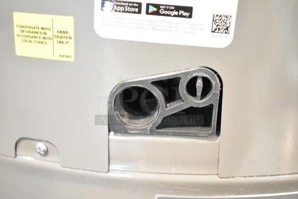 Rheem hot water heater, 208/240 volts, with a yellow label indicating drainage compliance. Appears in good condition.