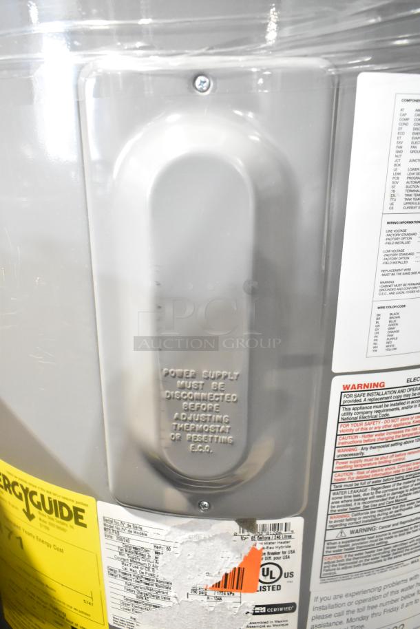 Rheem hot water heater, 208/240 volts, features a caution plaque and energy label. Appears in new condition with safety warnings.