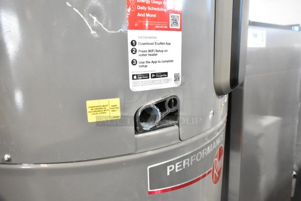 Rheem COC1I8V hot water heater, 208/240 volts, in unused condition. Features EcoNet app setup instructions and drainage label.