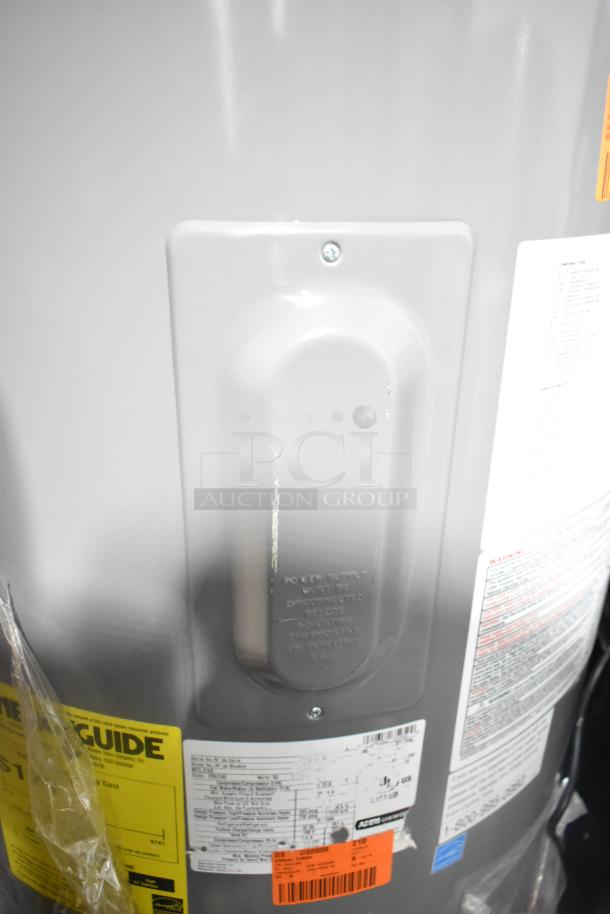 Rheem COC1I8V Hot Water Heater, 208/240 Volts. Includes energy guide labels and manufacturer markings. New condition.