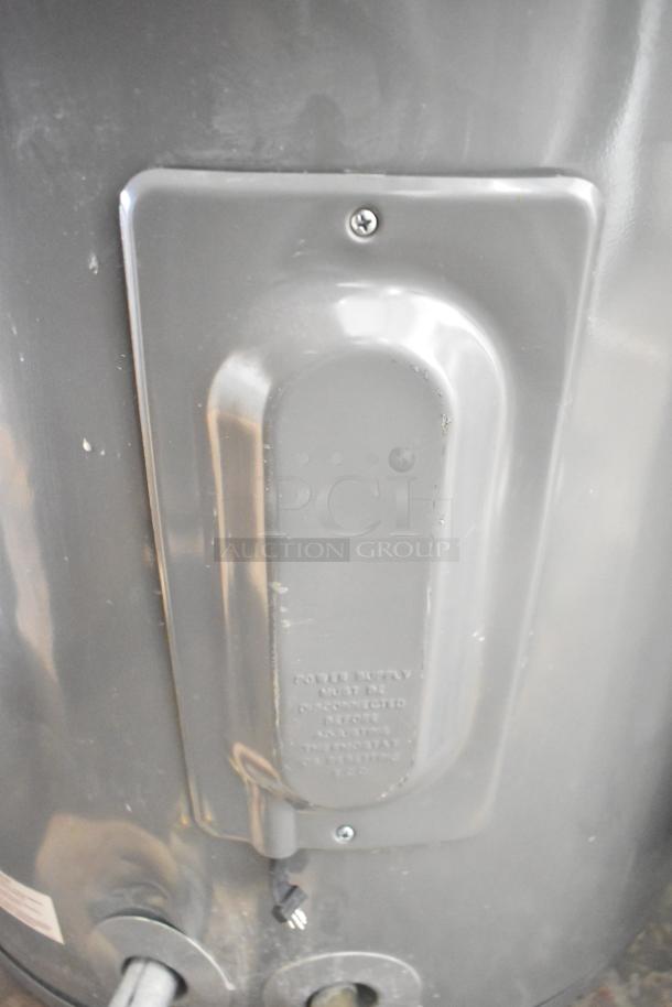 Rheem COC1I8V hot water heater, 208/240V, gray exterior, visible panel and warning label, good condition.