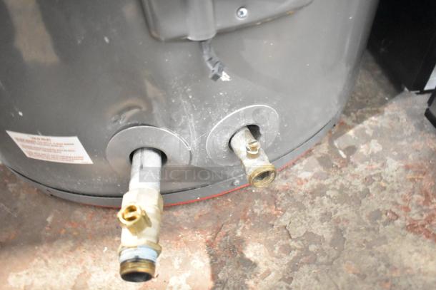 Rheem COC1I8V hot water heater, 208/240 volts, visible connections. Good condition, with label detail shown.