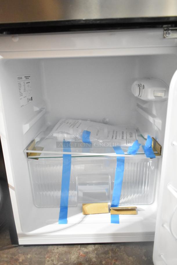 Brand new Vissani MDCM31SS5 mini cooler with freezer, 115 volts, showcasing scratch and dent condition. Interior details visible.