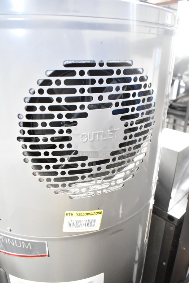 Rheem hot water heater with outlet vent, "RTV YELLOW/JAUNE" label, and metal finish, indicating energy efficiency.