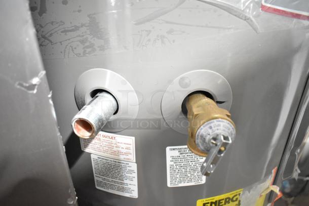 Rheem hot water heater with labeled outlets and fittings, indicating temperature relief and hot water outlet. Appears in good condition.