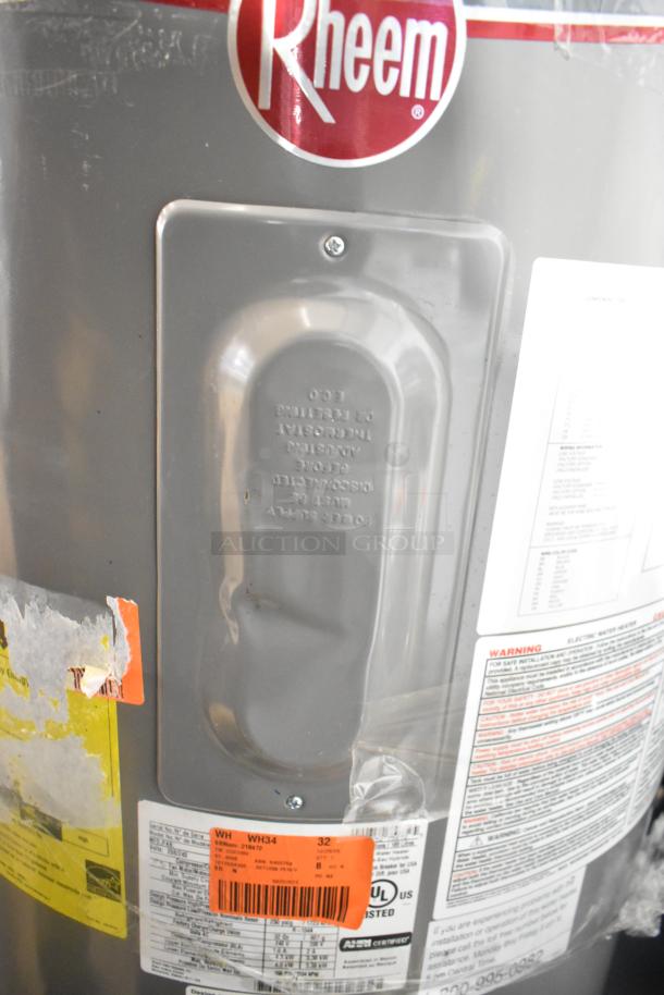 Rheem hot water heater with visible labels, warning text, and UL certification. Gray exterior, used condition.
