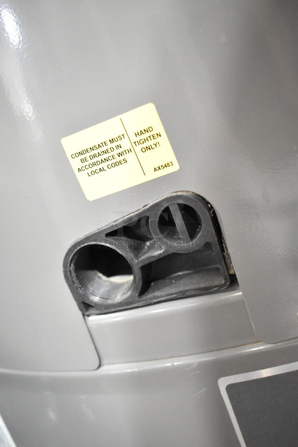 Rheem COC1I8V Hot Water Heater, 208/240V, features a label instructing proper drainage and installation.