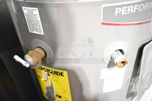 Rheem COC1I8V hot water heater, 208/240V, silver, with energy guide and maintenance labels, good condition.