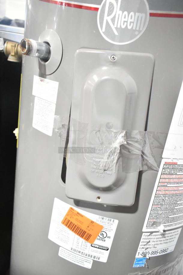 Rheem COC1I8V hot water heater, 208/240V, gray, with visible labels and UL certification tag.