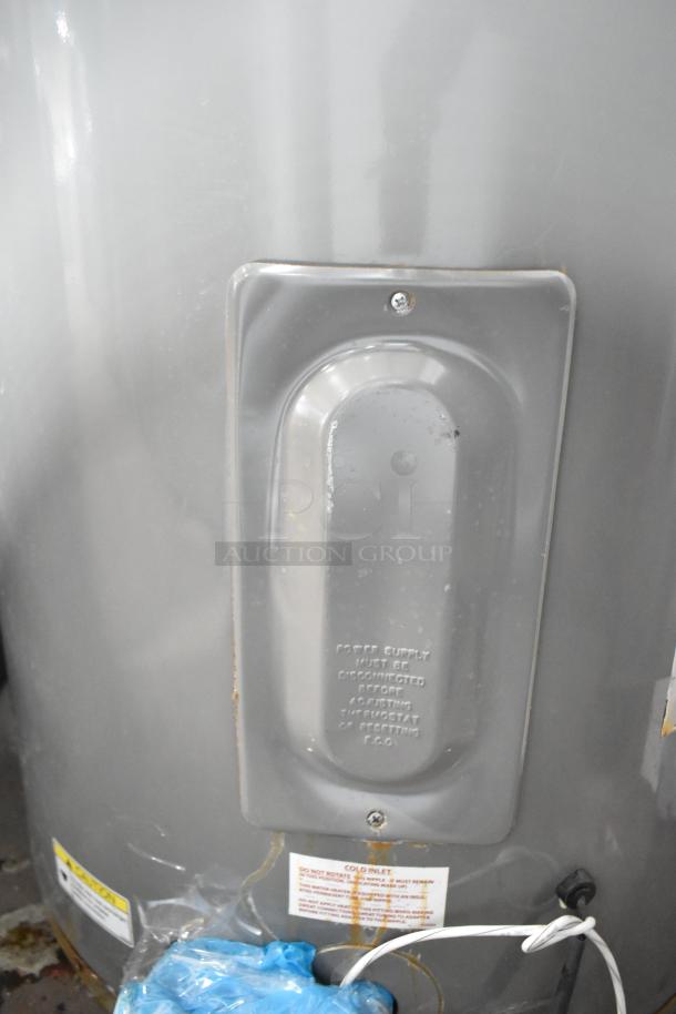 Rheem COC1I8V Hot Water Heater, 208/240 Volts. Features external access panel with caution label. Good condition.