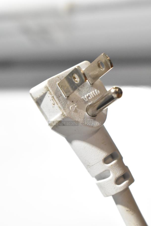 Close-up of a white power plug, part of the Vissani HMCF5W5 2025 chest freezer, 115 volts, 1 phase, showing minor dirt.