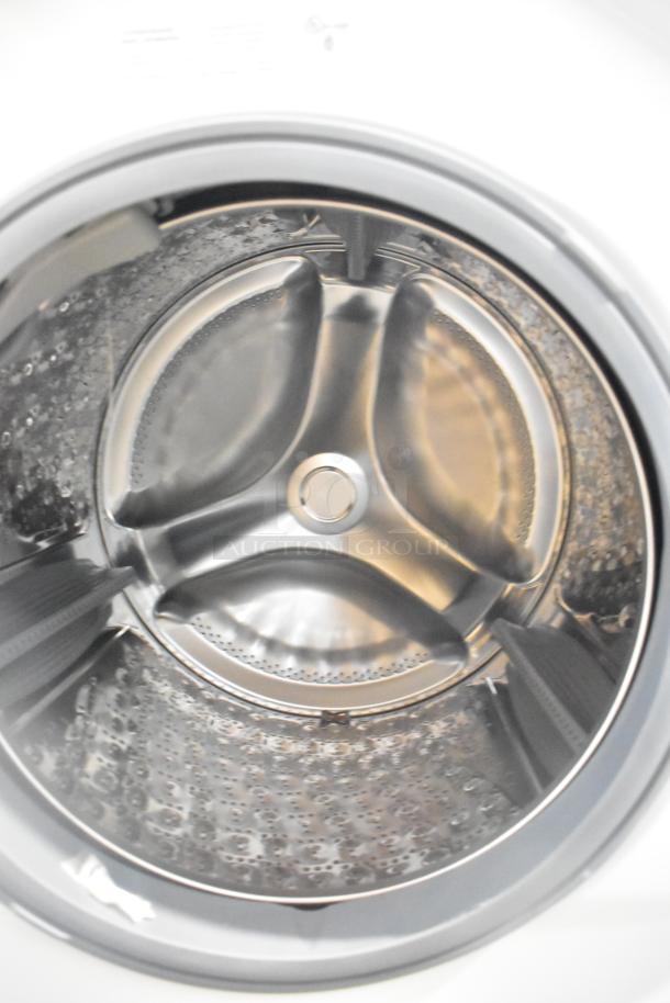 Brand new Samsung WF45B6300AW/US front load washer, visible stainless steel drum, scratch and dent condition.