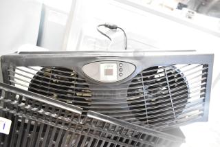 AirCare fan with dual blades and digital control panel, model label visible, black casing, appears in good condition.