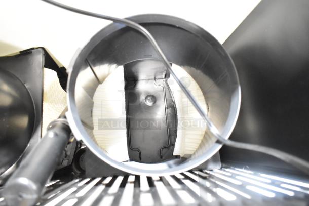 AirCare Fan with black housing, visible fan blades, and electric cord, showing its interior view; in good condition.