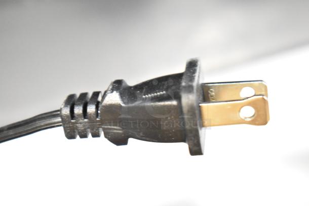 Power plug attached to an AirCare Fan, showcasing its sturdy design and compatible two-prong connection.