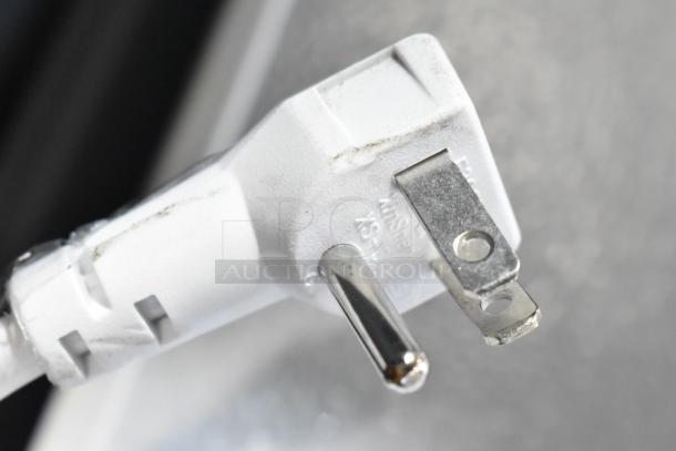 Close-up of a white power plug for the Vissani HMCF7W5 chest freezer, showing a standard 115V connection.