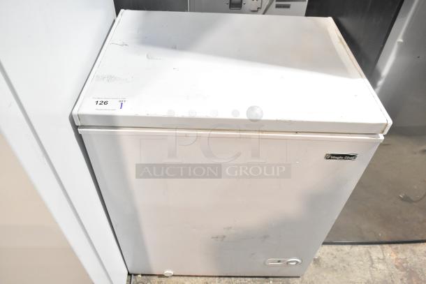 Magic Chef HMCF5W4 chest freezer, 5.0 cu. ft., 115V, new with scratches and dents, visible brand label and auction tag.