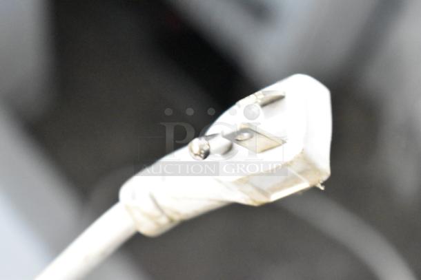 Close-up of a white electrical plug for Magic Chef HMCF5W4 chest freezer, 115 Volts, 1 Phase, showing prongs.