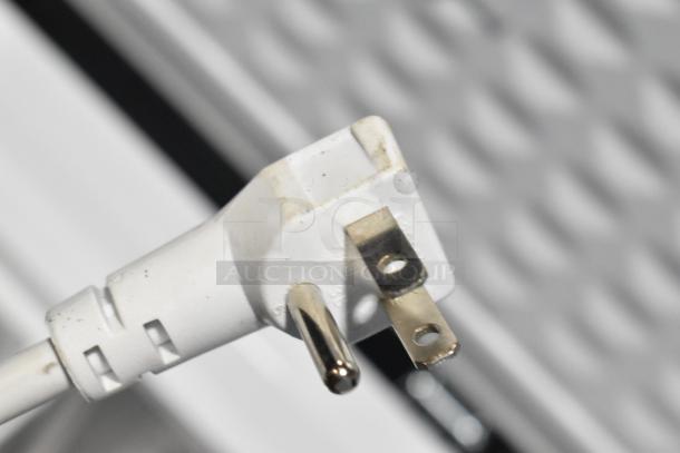 Close-up image of a white electrical plug for the Magic Chef HMCF5W4 chest freezer.