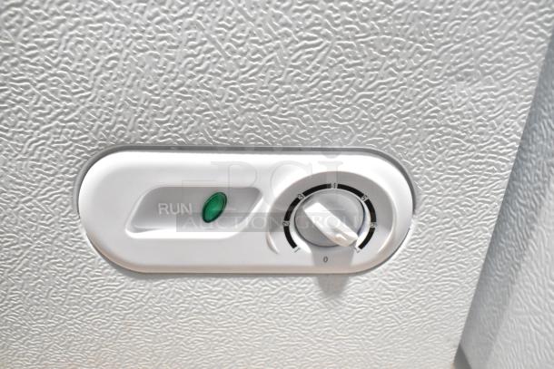Magic Chef HMCF5W4 chest freezer control dial with temperature settings and a green "Run" indicator light.