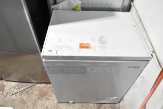 Brand new 2025 Magic Chef HMCF5W4 5.0 cu. ft. chest freezer, 115 volts, with minor cosmetic dents. Item sticker visible.