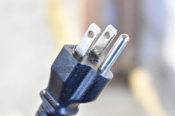 Close-up of a power plug. No visible Keurig K-4550 coffee machine features or markings shown.