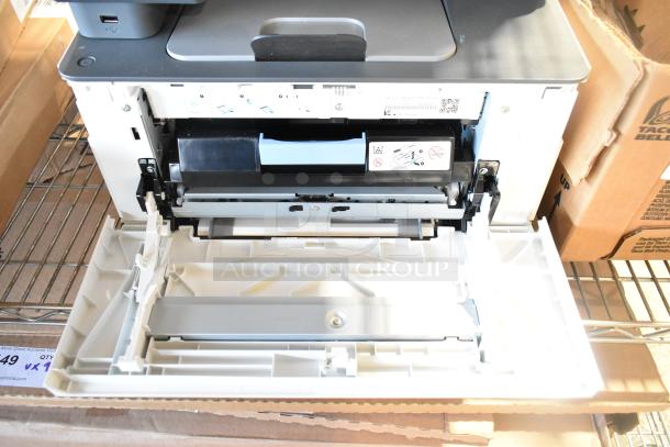 HP Color LaserJet MFP 3301sdw printer with open paper tray, showing internal components and maintenance instructions.