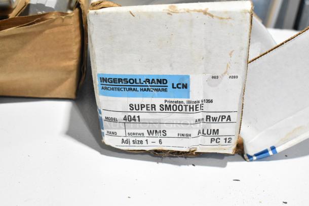 Box of various items including Ingersoll-Rand 4041 door closer. Label shows model, aluminum finish, adjustable size 1-6.