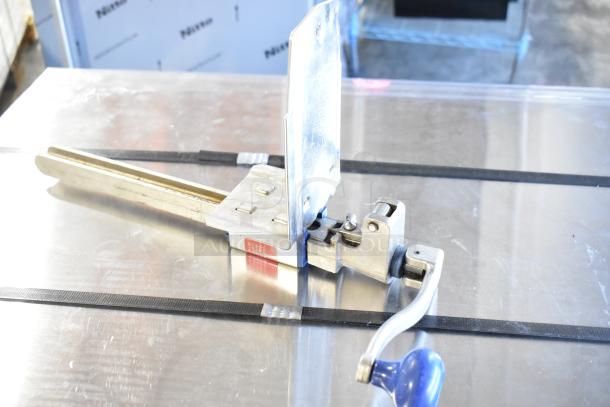 Edlund commercial can opener with mount, stainless steel, manual operation, appears in good condition, Edlund brand visible.