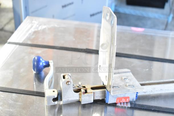 Edlund commercial can opener with mount, featuring a blue handle, metal body, and mounting plate, lightly used condition.