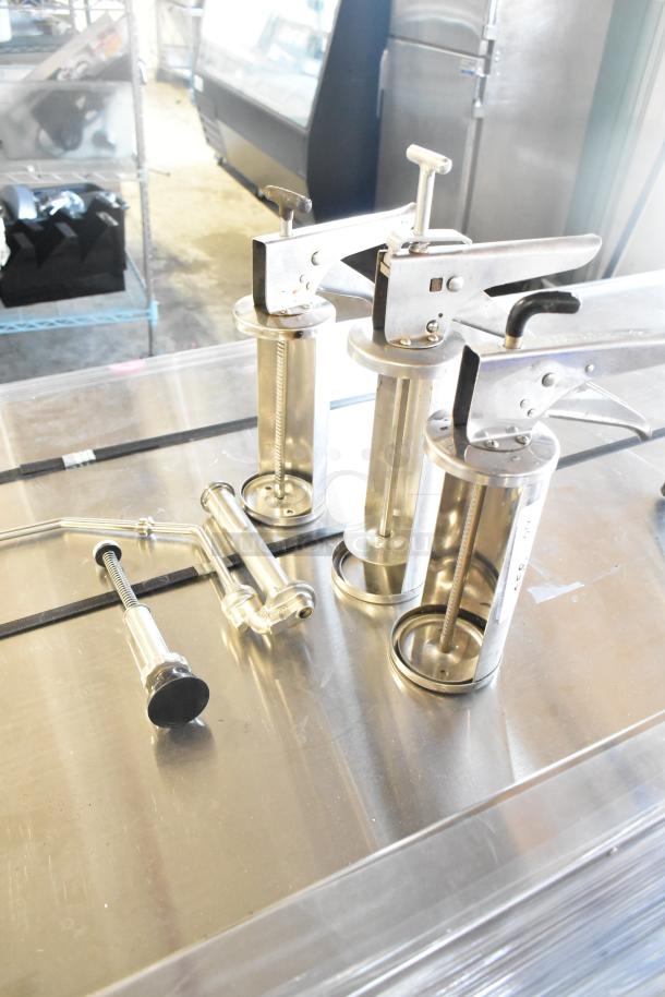 Five various metal tools including pump piece and caulk guns, good condition, ideal for construction or repair use.