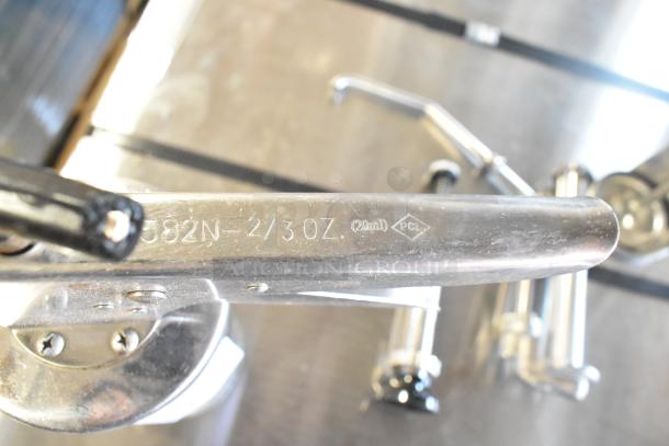 Various metal pump piece featuring "582N-2/3 OZ. (20ml) PCL" engraving, part of a lot including caulk guns.