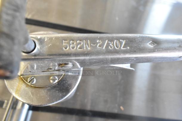Metal tool with marking "582N-2/30Z", part of a lot including pump piece and caulk guns, auctioned at 5 times bid.