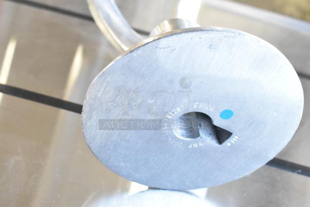 Commercial dough hook attachment for Hobart mixer, metal construction, visible markings with model and serial numbers.