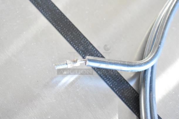 Close-up of a metal connector with wiring on a shiny surface, part of a 2 Round Burner unit. Condition appears used.