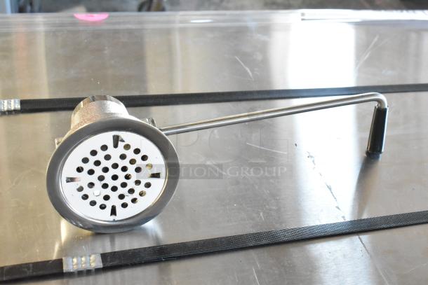 Brand new Regency 600DT1 twist handle waste valve, 3.5" sink opening, minor scratches and dents, shown on metallic surface.