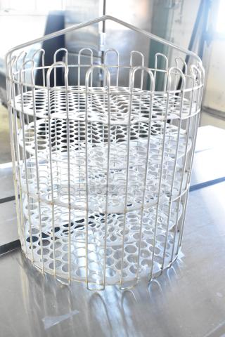 Brand new metal rack with scratch and dent. Features circular metal design. Excellent for storage or display.