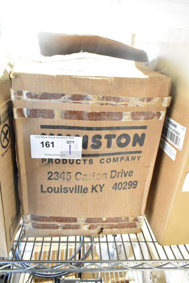 Cardboard box labeled "Fiston Products Company," containing a brand new, scratch and dent metal rack, located at 2345 Carton Drive, Louisville KY 40299. Box shows wear.