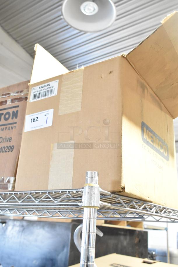 Cardboard box labeled “Nemco 55200AN Vegetable Slicer.” Box is new with minor dents, indicating "scratch and dent."