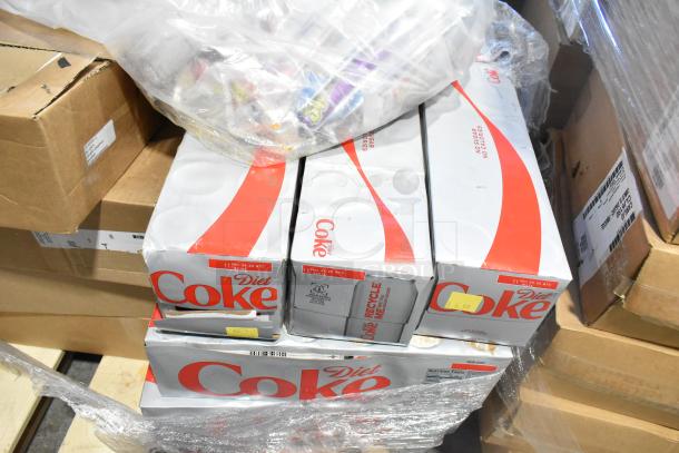Boxes of Diet Coke, partially wrapped in plastic, next to cardboard containers. Labels show expiry date and recycling info.