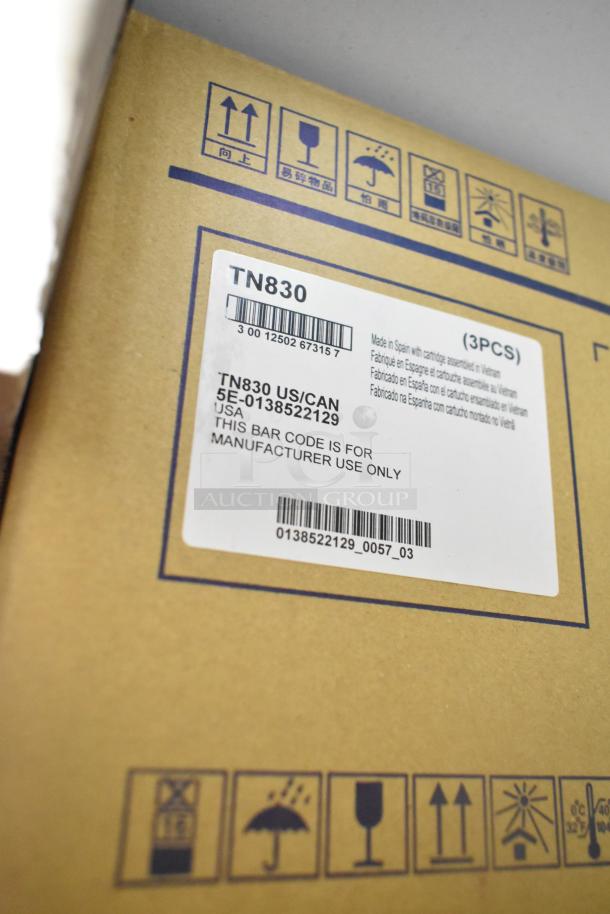 Label on a cardboard box indicating TN830 model, made in Spain. Warning symbols for handling and storage.