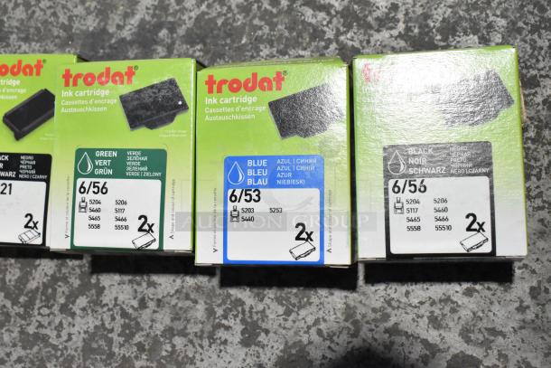Trodat ink pads in green, blue, black; new condition, model numbers 6/56 and 6/53, 98 items total, multiple languages on packages.