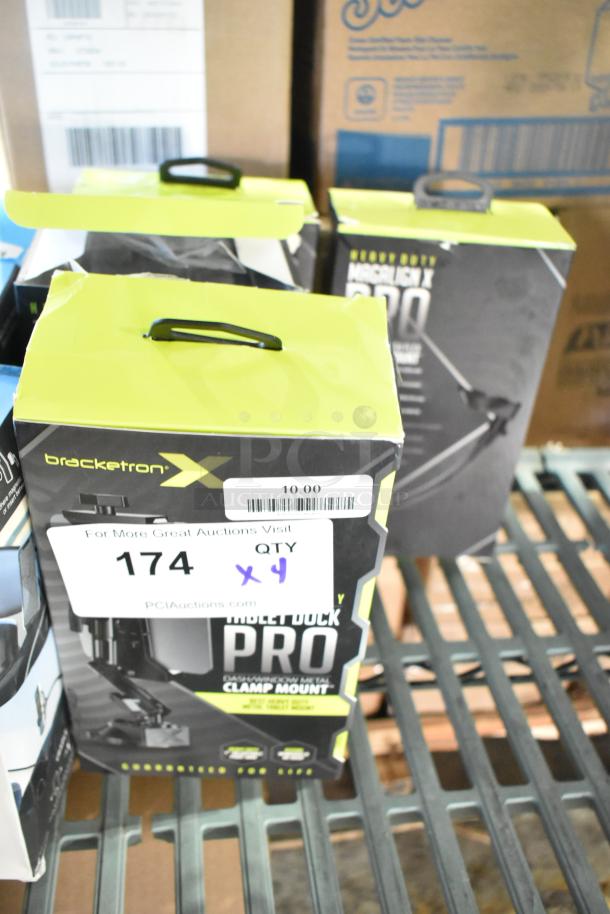 Four Bracketron Magalign X Pro magnetic mounts, brand new, with slight scratches and dents. Packaging shows model details.