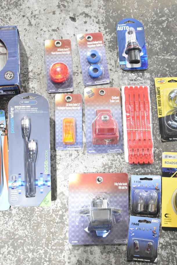 Assorted brand new scratch and dent items including coax cable, emergency beacon, hose clamps, and more, with original packaging.