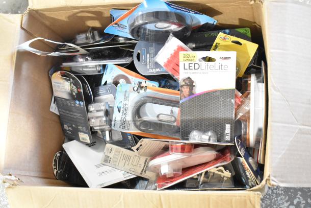 Box of 179 brand new scratch and dent items including coax cables, LED LifeLite, hose clamps, and emergency beacons.