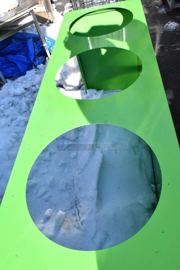 Green recycling bin shell with 3 trash deposit holes in snowy outdoor setting. Good condition. Auction item: Double Bid!
