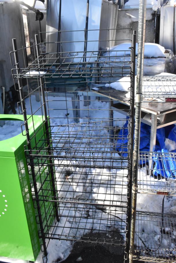 Black 4-tier wire shelving unit, sturdy metal construction, snow in background. Buyer must dismantle, consider freight charges.