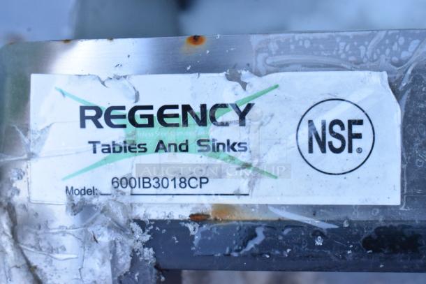 Regency 600IB3018CP stainless steel ice bin label with model and NSF mark, showing some surface wear.