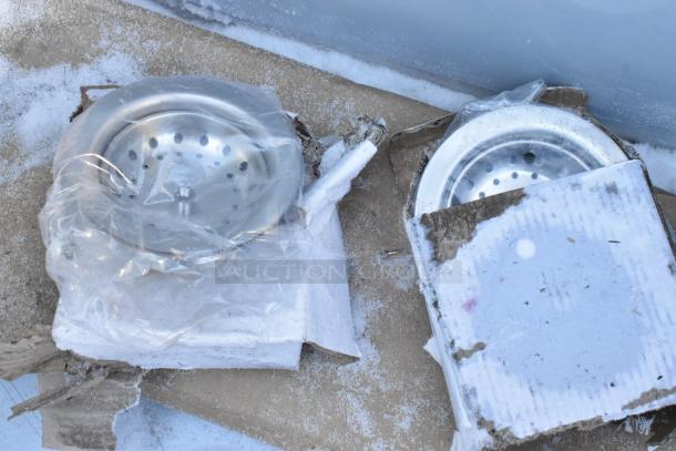 Brand new Regency 2 Bay Sink, scratch and dent condition. Visible parts still in original protective packaging on snowy ground.