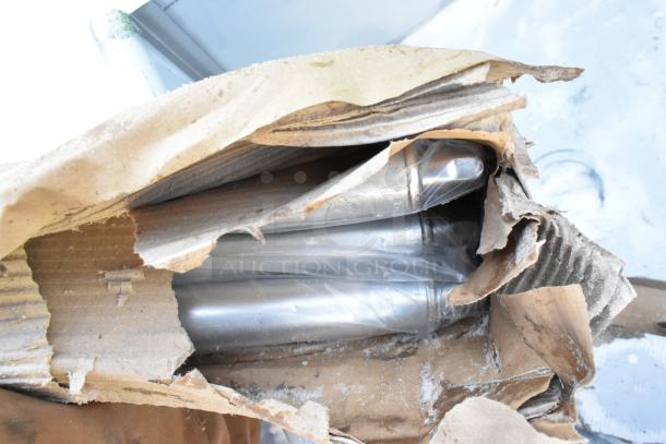 Damaged packaging reveals Regency 2 Bay Sink, brand new, visible scratches and dents, partially wrapped in plastic.